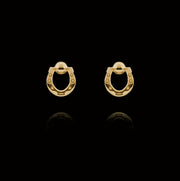 Designer solid 9ct gold horseshoe stud earrings on black background.