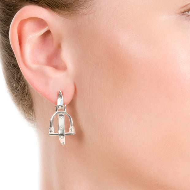 close up of model wearing  Designer solid silver vintage stirrup drop earrings with silver leather strap detail.