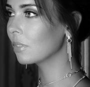model wearing designer solid silver chain equestrian styled drop earrings Black and white image