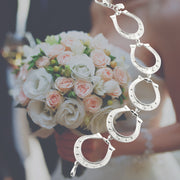 bride wearing Designer solid silver large horseshoe bracelet.