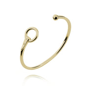 Designer solid 9ct yellow gold torque style equestrian styled bangle on white background.