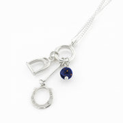 Designer solid silver horseshoe, stirrup and Lapis lazuli charm necklace on white background