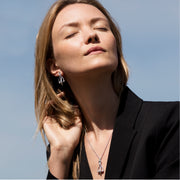 model wearing Designer solid silver vintage stirrup drop earrings with silver leather strap detail and matching necklace.