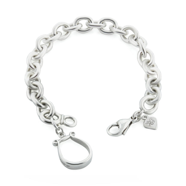 Designer solid silver western stirrup heavy chain bracelet on white background.