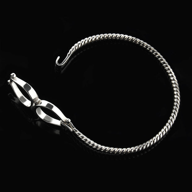 Solid silver double western stirrup opened bangle on black.