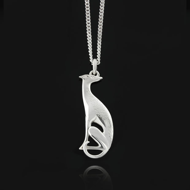 Designer solid silver hand carved hound necklace on a black background.
