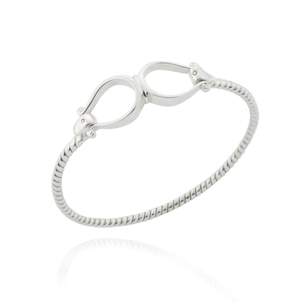 Solid silver double western stirrup opening bangle on white.