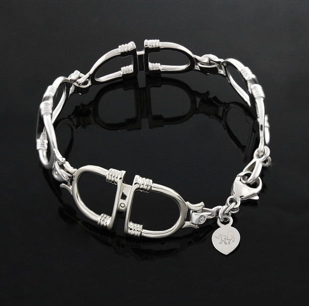designer solid silver stirrup and leather strap bracelet on black background