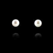  Cultured pearl earrings white gold fittings on black background.