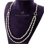 designer double strand of grey and cream pearl with stirrup detail necklace on purplejewellery display bust