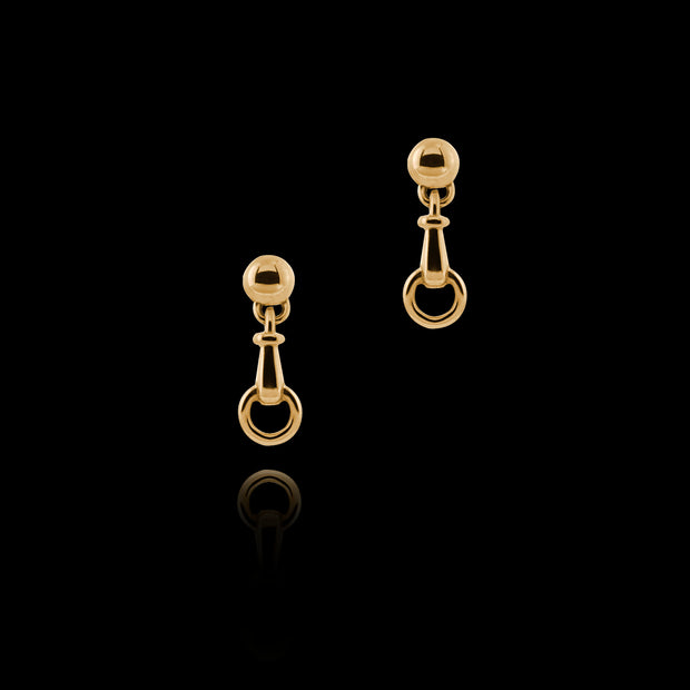 designer solid 9ct yellow gold horse bit inspired drop earrings on black background.