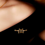 Model wearing designer solid gold and eight diamond, horsebit stockpin brooch.