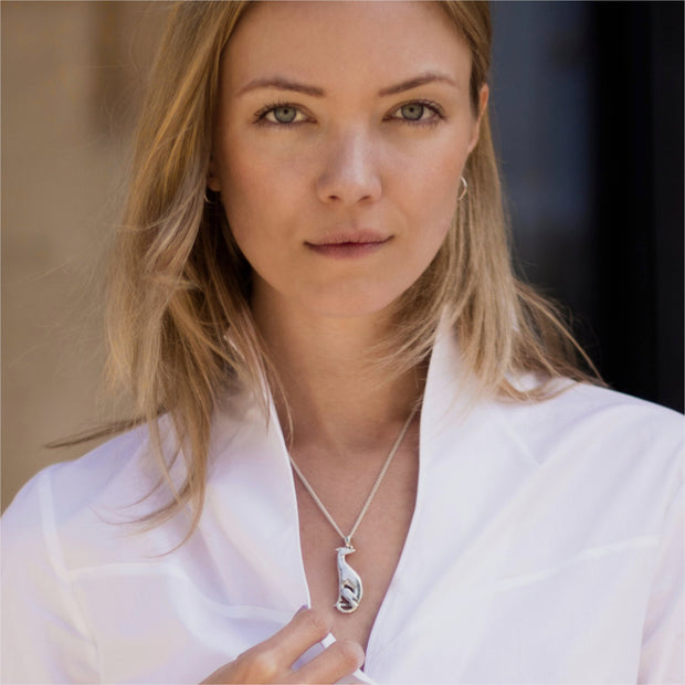 model wearing silver hand carved hound necklace