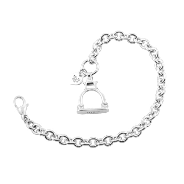 Designer solid silver heavy weight chain bracelet with vintage stirrup inspired large charm on white background.