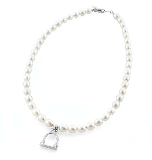 designer cultured pearl necklace with vintage solid silver stirrup design charm on white background.