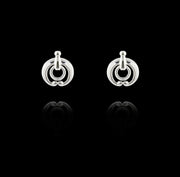designer silver equestrian stud earrings on black background