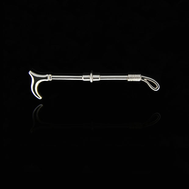 designer solid silver crop stockpin brooch on black background with reflection