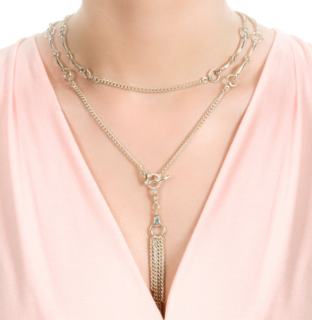 solid silver model's neck showing equestrian chain tassel with caribiner clip on a white background