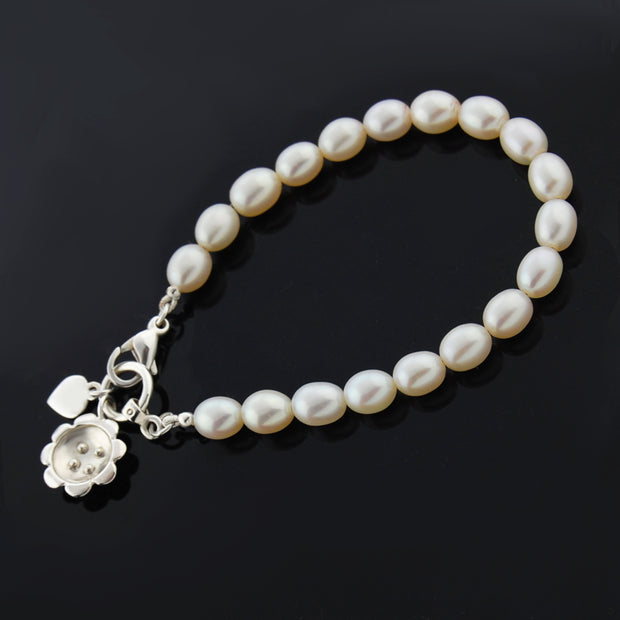 designer silver and pearl bracelet with retro daisy charm