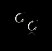 designer solid silver leather strap hoop earrings on black background