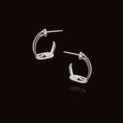 designer solid silver stirrup inspired hoop earrings on a black background.