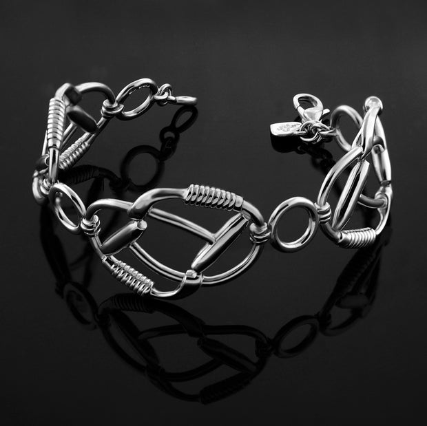 Designer solid silver double polo mallet Signature Bracelet on black background.