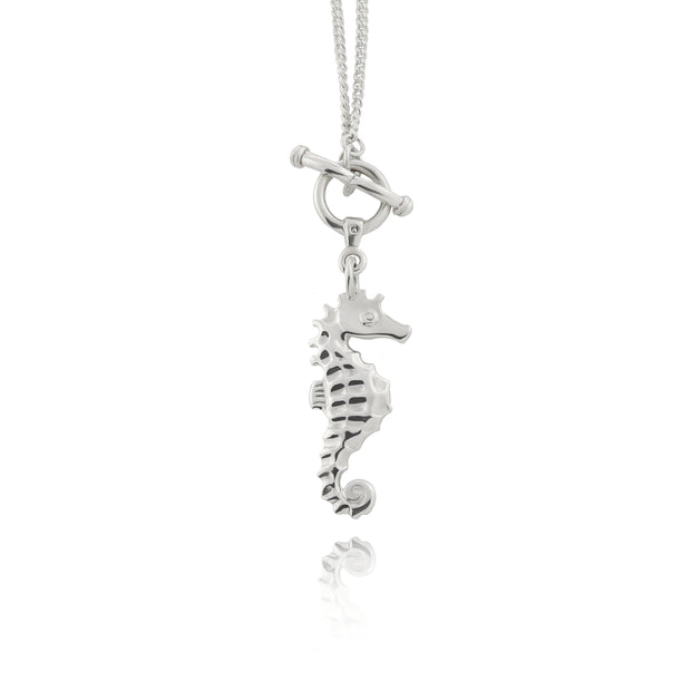 solid sterling silver designer handcarved silver seahorse necklace with toggle and ring feature clasp.