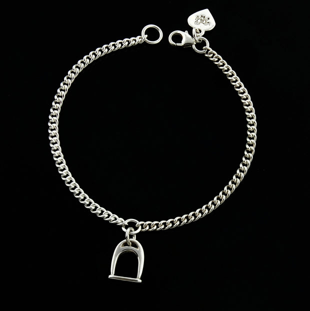 designer  solid silver stirrup and chain bracelet on black  background.