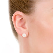 close up of model wearing 9mm button cultured pearl studs with 9ct white gold fittings.