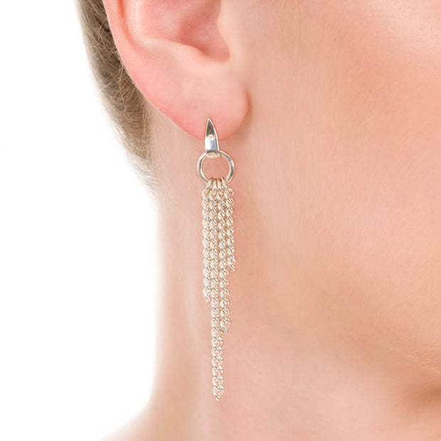 image of model's ear wearing designer solid silver chain equestrian styled drop earrings on white background