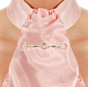 Close up image of model wearing Designer Solid silver horsebit stockpin brooch on pink silk riding stock.